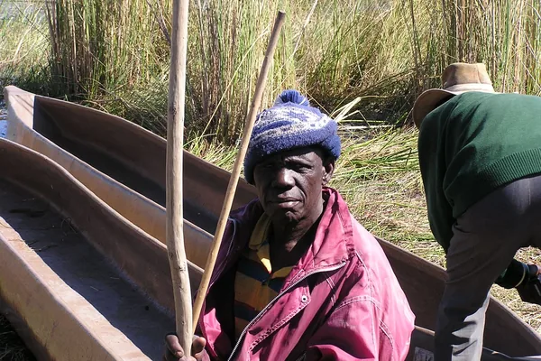 Mokoro polers in the reeds of the Okavango Delta