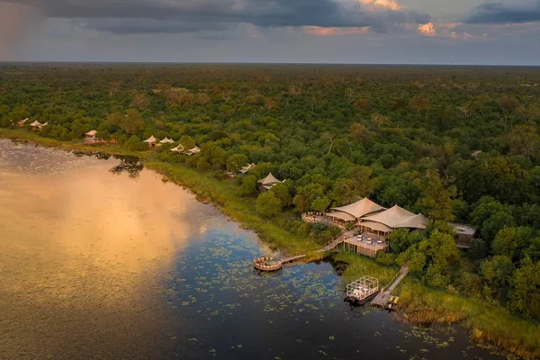 DumaTau camp on the Linyanti waterway from the air, with its lagoon at sunset
