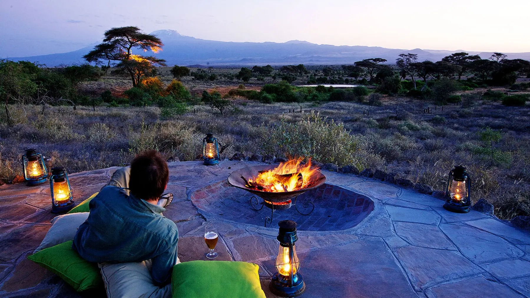 Kingse guests around the firepit with Kilimanjaro behind