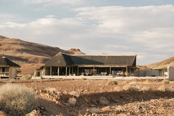 Damaraland Camp's main building against the hills of the Huab River valley