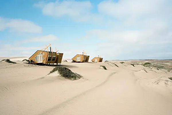 The shipwreck-shaped cabins of Shipwreck Lodge on the dunes of the Skeleton Coast