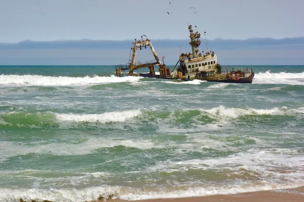 A rusting shipwreck in the surf on Namibia's Skeleton Coast