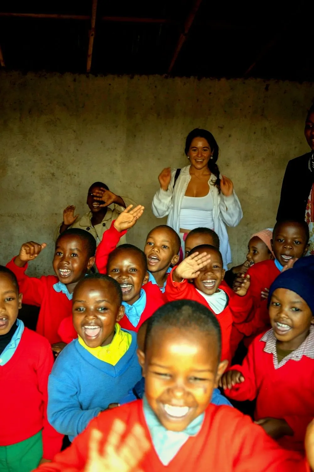 Schoolchildren cheering and waving in a classroom at the Nanyaro Foundation school in Karatu, Tanzania