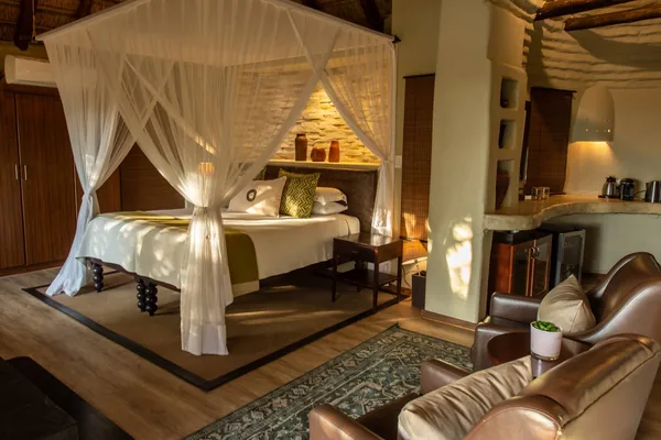A four-poster bed in a suite at Impodimo Game Lodge, Madikwe