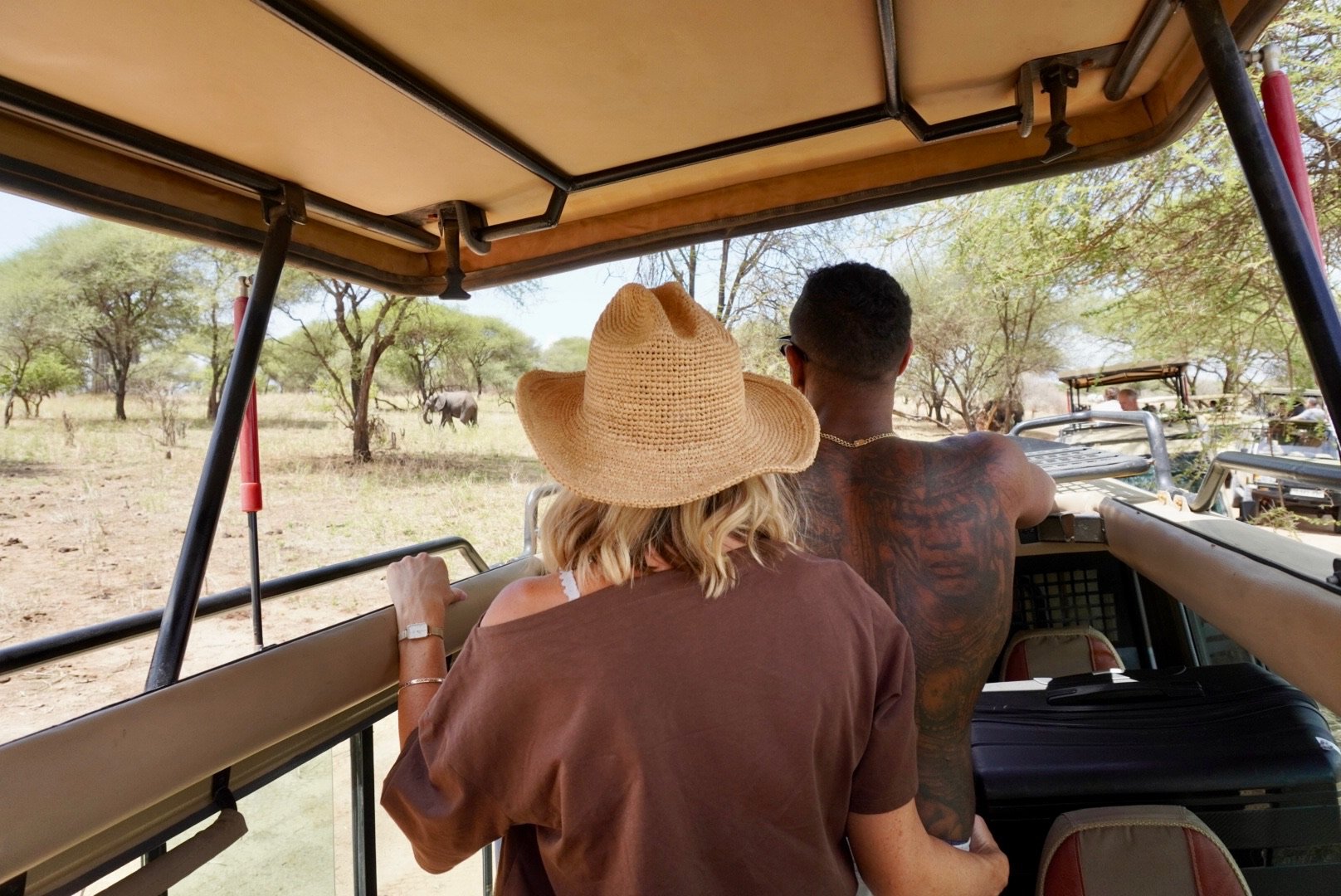 A family on a private game drive watching wildlife in Tanzania
