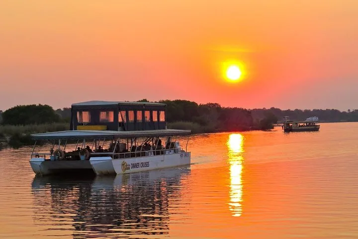 A Zambezi cruise boat on the river at sunset