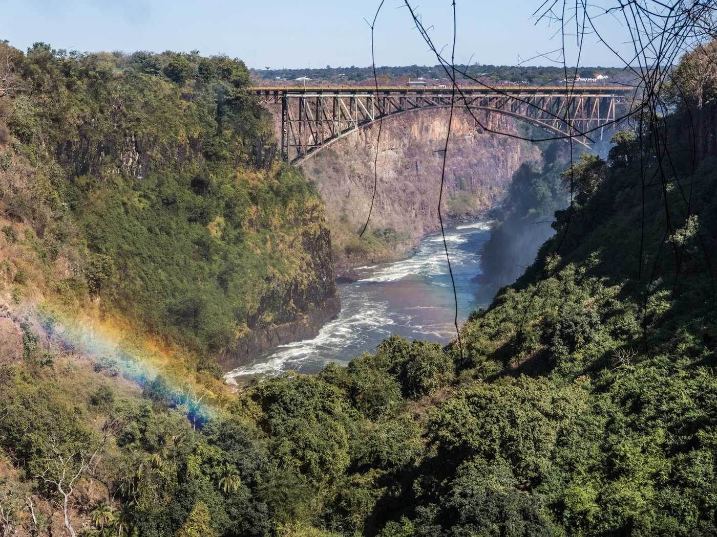 The Victoria Falls Bridge above the Batoka Gorge, with a rainbow in the spray