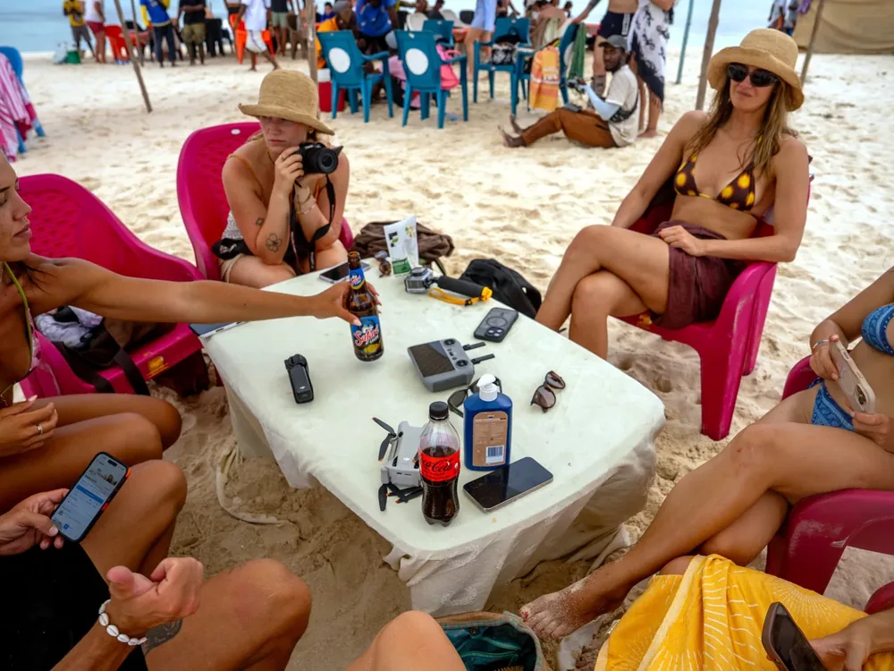 Guests at a lunch table set on a sandbank in the sea